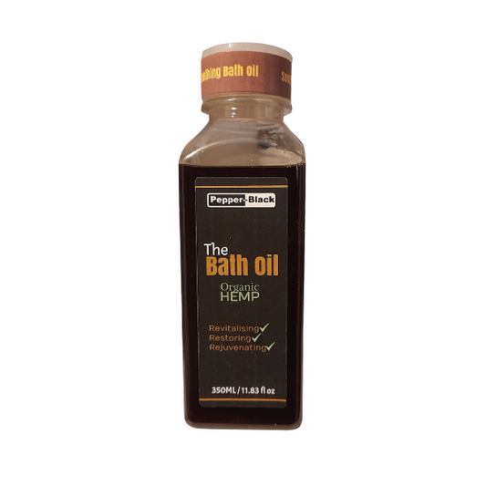 Bottle of 'The Bath Oil' with a brown cap on a white background