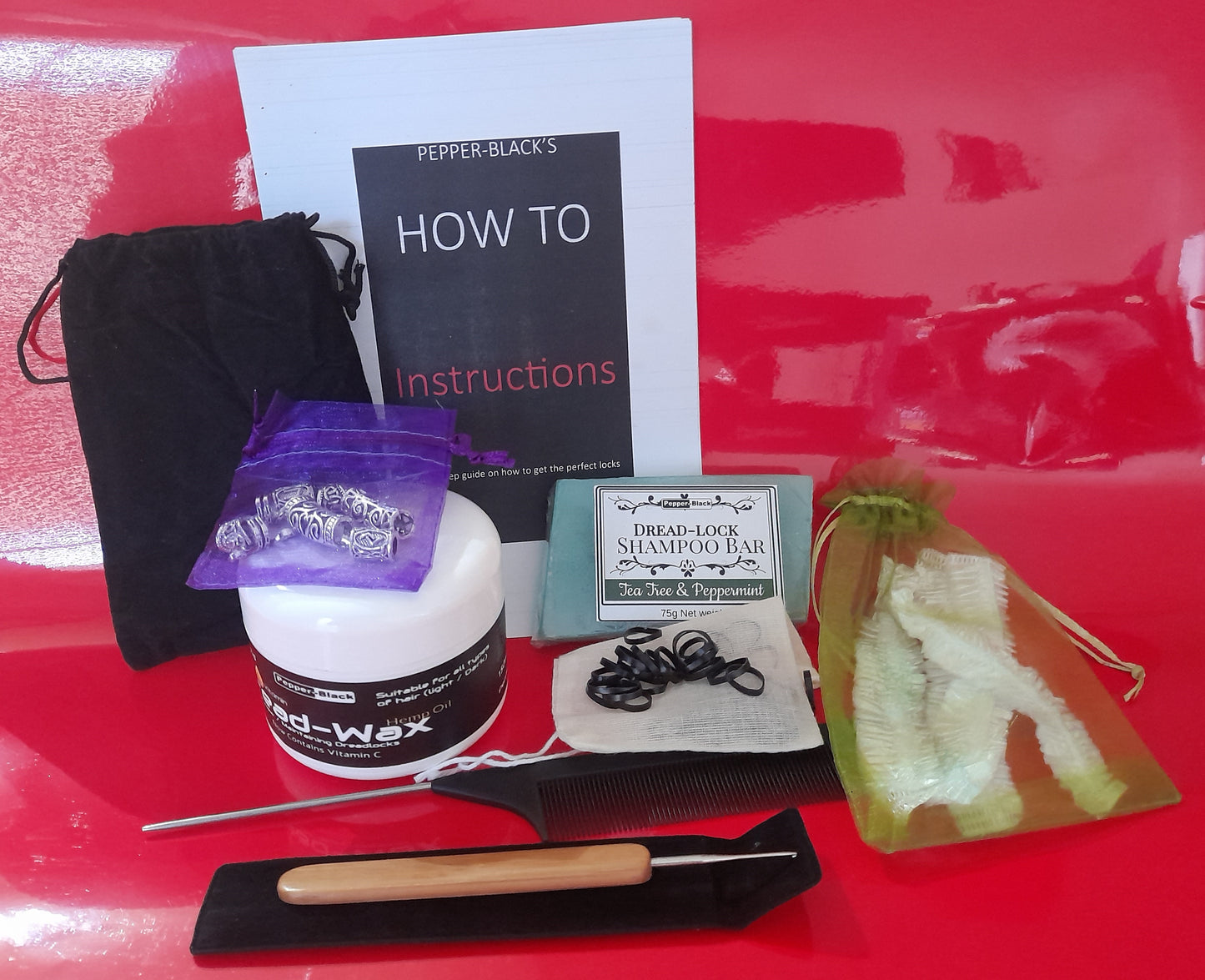 Set of hair care products and tools on a red surface with 'How To' instructions.