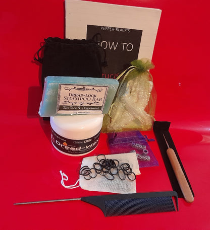 Collection of hair care products including shampoo bar, jar, comb, and hair ties on a red background.