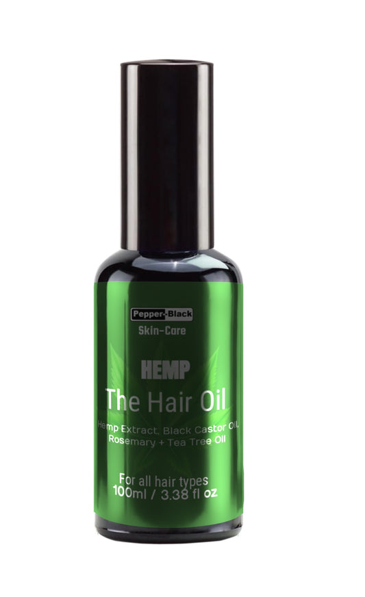 Green bottle of Hemp Hair Oil with black cap on a white background