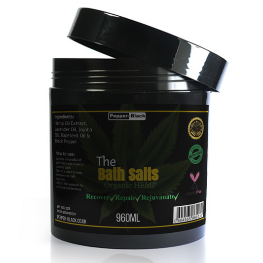 Black container of 'The Bath Salts' with a label on a white background