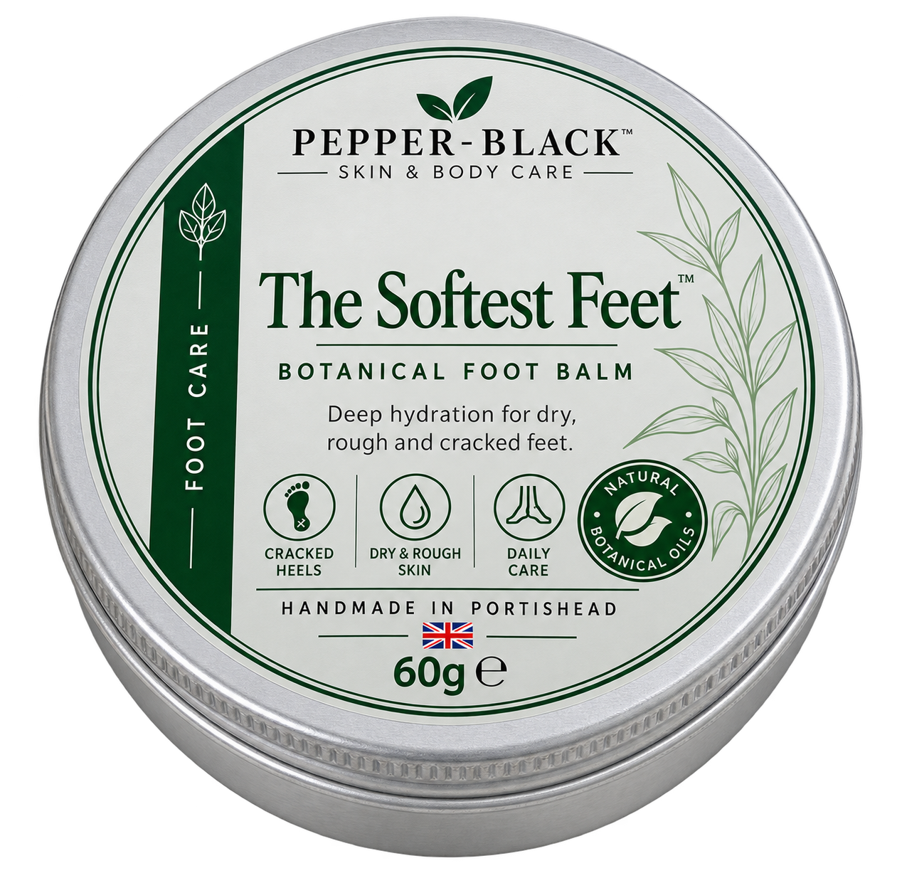 A round silver metal tin of Pepper-Black 'The Softest Feet' Botanical Foot Balm, featuring a white and green label with product details and icons, on a plain white background.